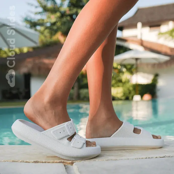 White Bloom sandals worn by the pool